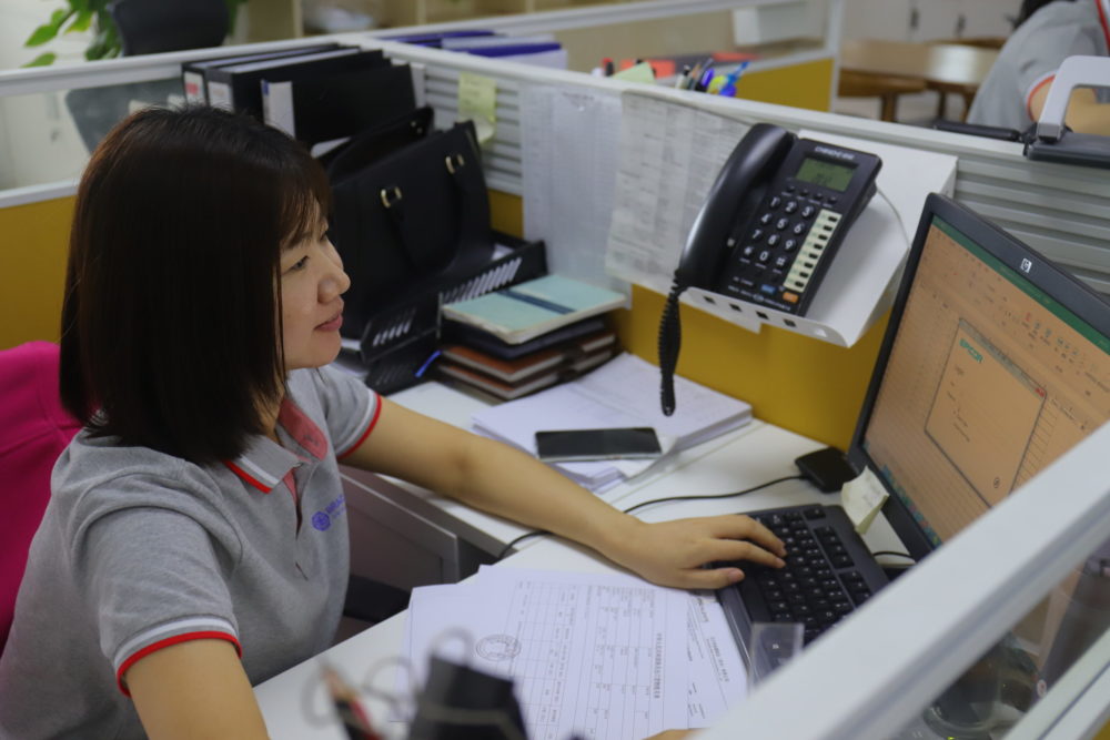 bracalente team member working at a desk at the china location