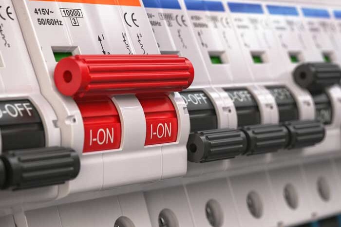 Switches in fusebox. Many black circuit brakers in a row in position OFF and one red switch in position ON. 3d illustration